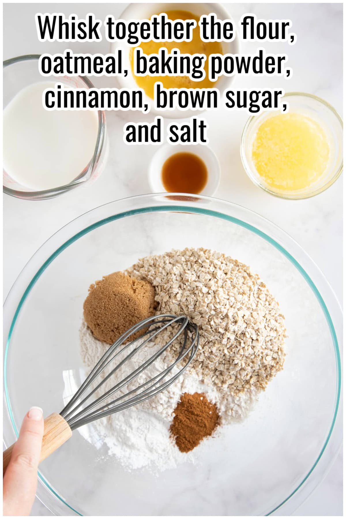 A mixing bowl with flour, oats, brown sugar, cinnamon, and a whisk. Text on the image says 'Whisk together the flour, oatmeal, baking powder, cinnamon, brown sugar, and salt'.
