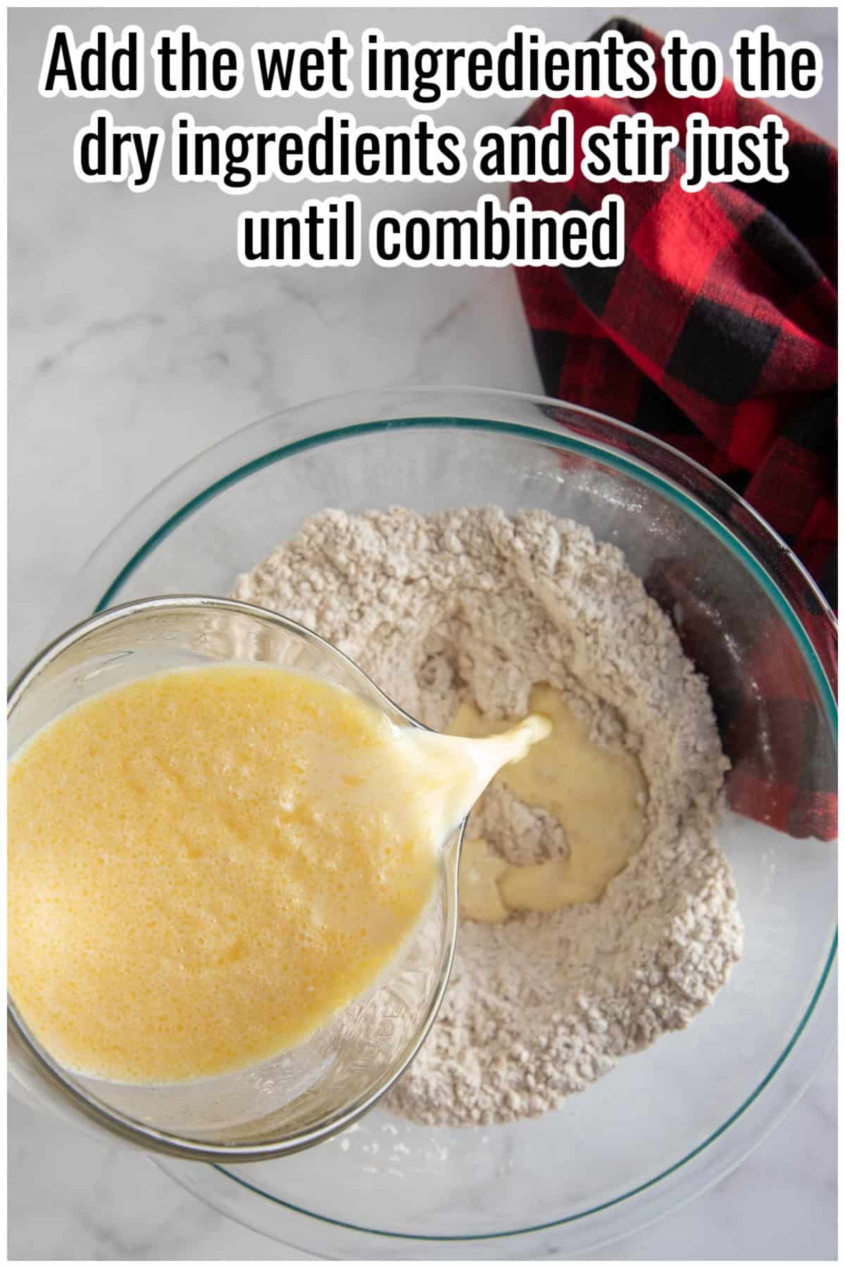 Wet ingredients being poured into a bowl of dry ingredients. Text on the image says 'Add the wet ingredients to the dry ingredients and stir just until combined'.