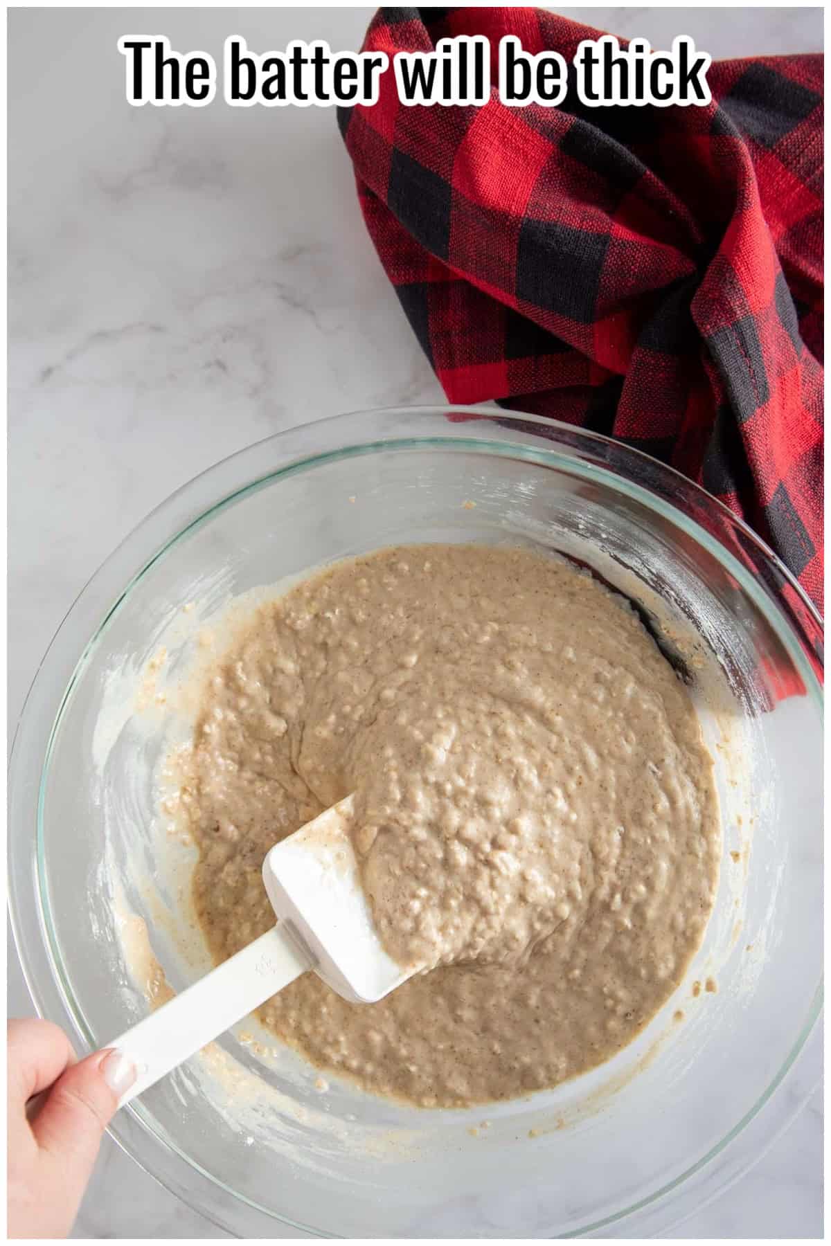 A spatula lifting thick waffle batter from a glass bowl. Text on the image says 'The batter will be thick'.