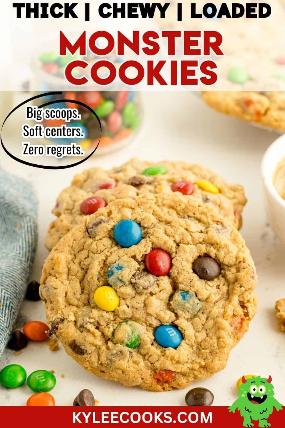 Two large cookies with colorful candy-coated chocolates on a white surface, surrounded by more candies and a bowl of dough. Text describes them as thick, chewy, and loaded monster cookies.
