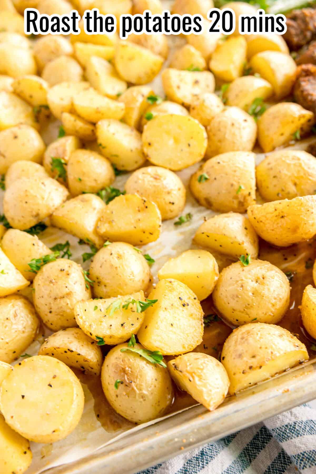 Roasted potato halves on a baking sheet, seasoned with herbs, with text that reads "Roast the potatoes 20 mins.