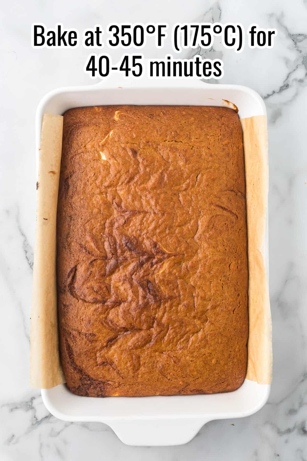 A rectangular baked cake in a white ceramic dish, with text overlay reading “Bake at 350°F (175°C) for 40-45 minutes.”